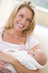 Mother in living room with baby smiling