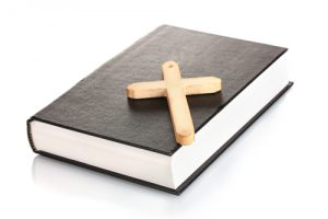 bible and wooden cross isolated on white